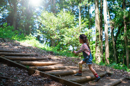 A child walking on the steps of the forestの写真素材