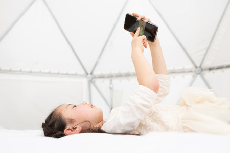 Girl using   smart phoneの写真素材