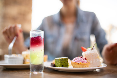 Woman eating sweets at a restaurantの写真素材