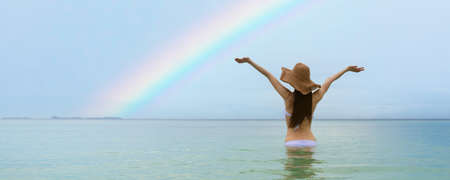 A woman relaxing on a rainbow beachの写真素材