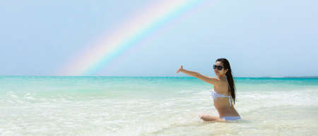 A woman relaxing on a rainbow beachの写真素材