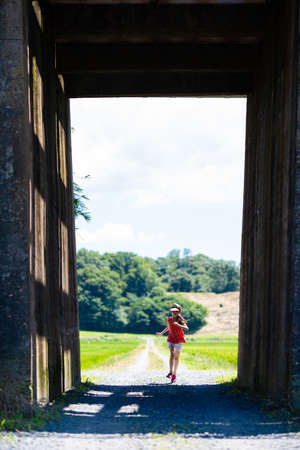 Rural scenery and girl on the other side of the tunnelの写真素材