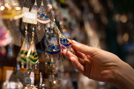 Women's hands choosing accessories at the storeの写真素材