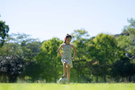 Girl playing with a soccer ballの写真素材