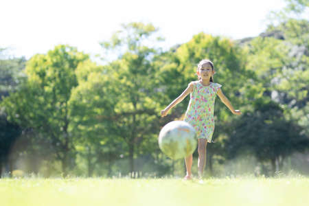 Girl playing with a soccer ballの写真素材