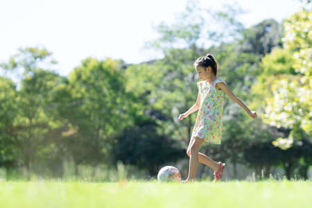 Girl playing with a soccer ballの写真素材