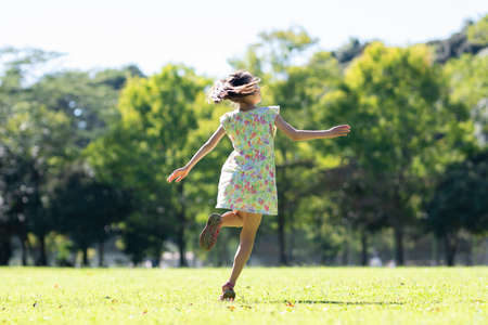 Girl dancing on the lawnの写真素材