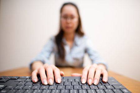 A woman operating a computer keyboard