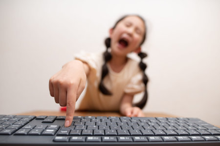 A child who presses the enter key on a computer keyboard