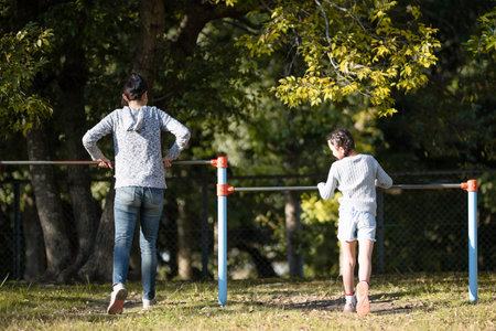 Mother and daughter playing horizontal bar