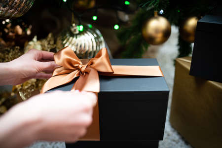 Female hand holding a Christmas presentの写真素材