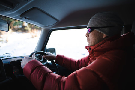 A man driving a car on a snowy road