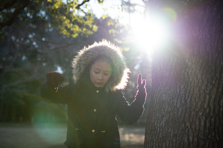 Girl playing in the winter forest