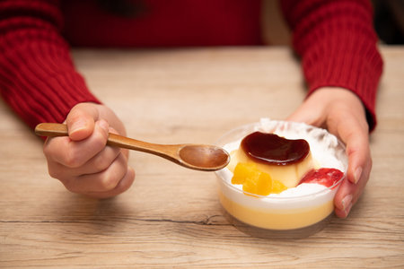 Girl eating puddingの写真素材
