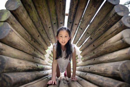 Girl playing in the forest parkの写真素材