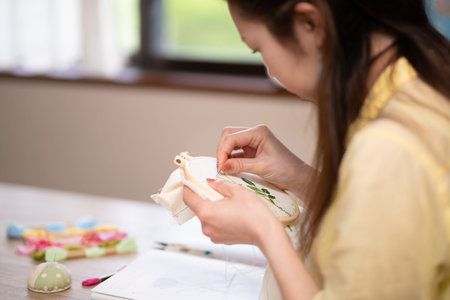 A woman doing embroidery leisurely in the room