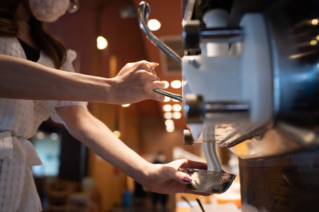 A woman's hand serving soft cream in a bowl