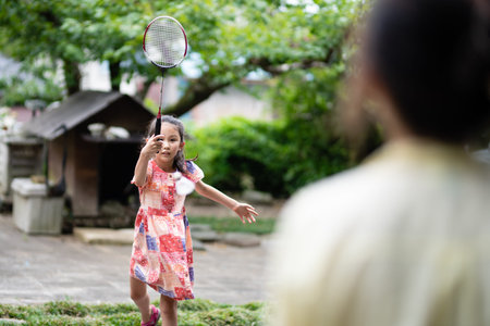 mother and daughter playing badminton