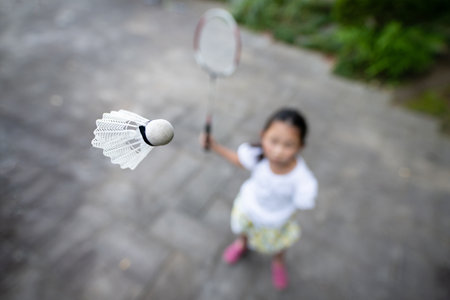 Child playing badminton in the parkの写真素材