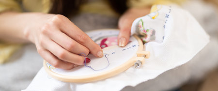 Hands of a woman who is embroidering