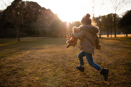 child running in the park at sunset