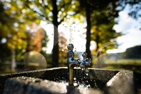 Drinking water at the water fountain in the parkの写真素材