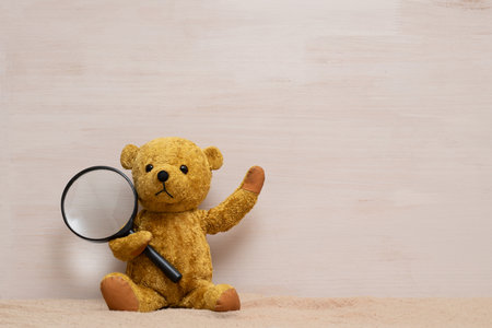 teddy bear with magnifying glassの写真素材