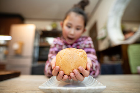 child eating big cream puffの写真素材