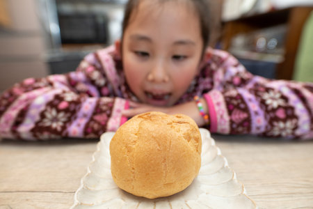 child eating big cream puff