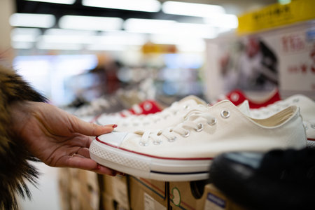 Female hands choosing shoes in the storeの写真素材
