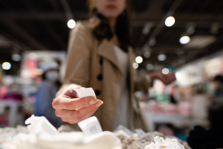 Female hands choosing clothes in the storeの写真素材