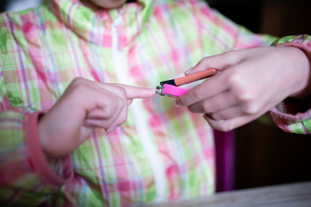 Hand of a child cutting nailsの写真素材