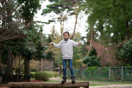 Girl playing in spring parkの写真素材