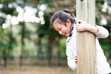 Girl playing in spring parkの写真素材