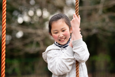 Girl playing in spring parkの写真素材