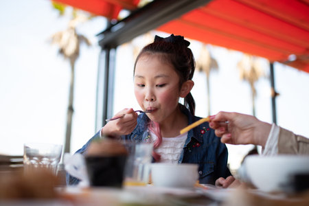 girl eating at a restaurantの写真素材
