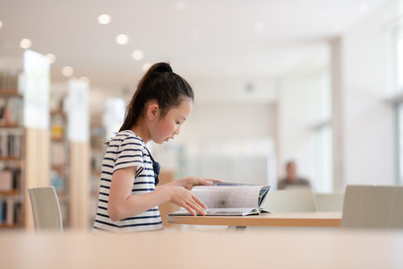 girl sitting and reading a bookの写真素材