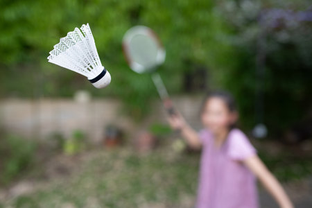 girl playing badminton in the gardenの写真素材