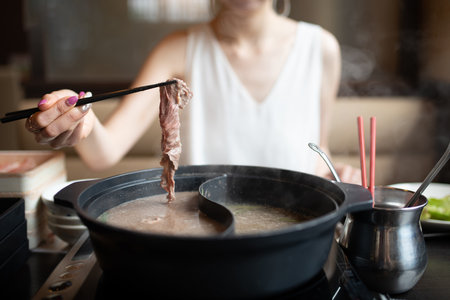 woman eating shabu shabuの写真素材