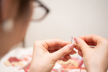 Close-up of a woman knitting with a needle in her handsの写真素材