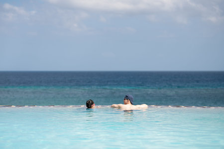 father and daughter playing in the pool