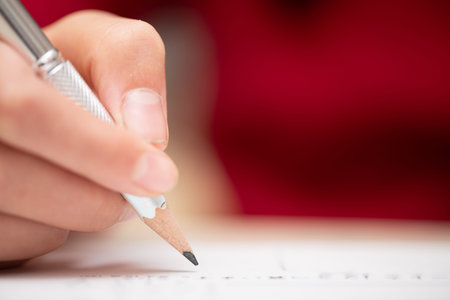 Hands of a child studying