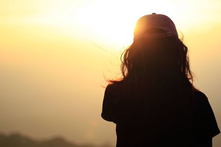 Girl standing at sunsetの写真素材