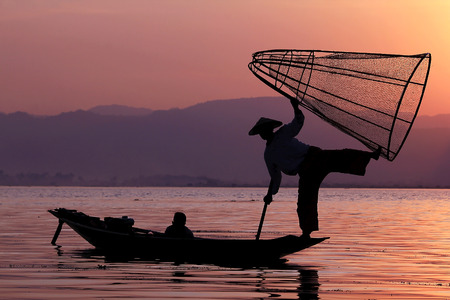 The silhouette of a fisherman in Inle Lakeの写真素材
