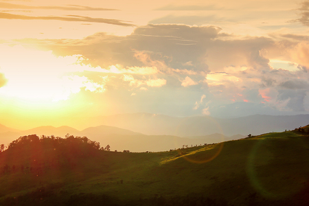 Orange light of sunset over the mountains.の写真素材