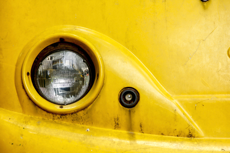 The old rusty yellow car headlights.の写真素材