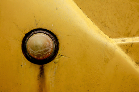 The old rusty yellow car headlights.の写真素材