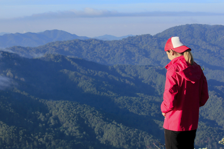 Women wear red shirts on the mountain.の写真素材