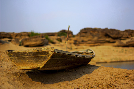 Old wooden ship damaged on dry ground.の写真素材