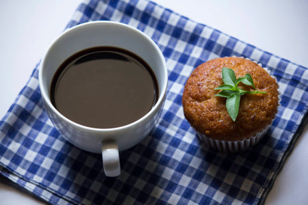 Black coffee in white glass and banana cake on cloth.の写真素材